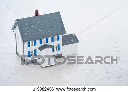 Stock Photograph - Studio Shot of artificial house during flood. Fotosearch