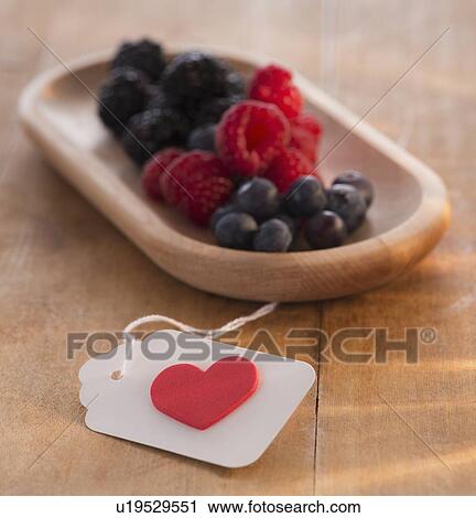Stock Image - Studio Shot of berry fruits in bowl. Fotosearch