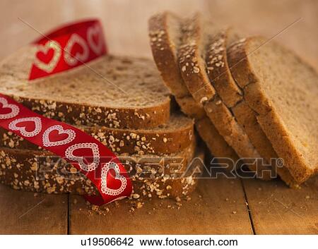 Stock Image - Studio Shot of bread slices with red ribbon. Fotosearch
