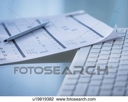 Stock Image - Studio Shot of calculator and paper material. Fotosearch