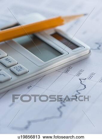 Stock Image - Studio Shot of calculator and paper material. Fotosearch