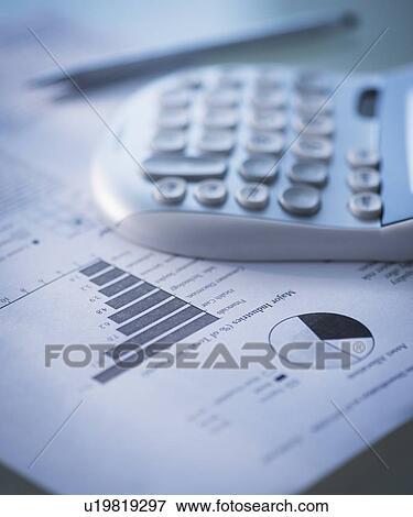 Stock Photo - Studio Shot of calculator and paper material. Fotosearch