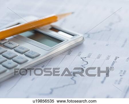 Stock Photography - Studio Shot of calculator and paper material. Fotosearch