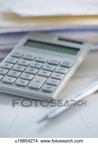 Picture - Studio Shot of calculator, pen and paper material. Fotosearch