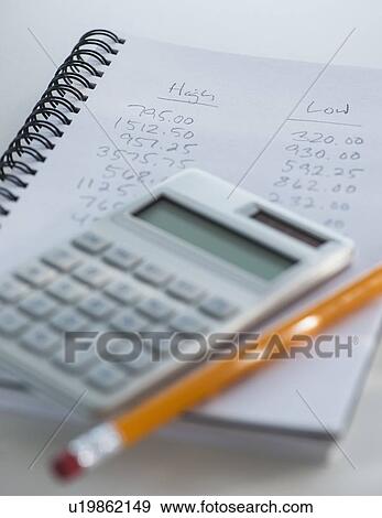 Studio Shot of calculator pen and spiral-bound notebook View Large Photo Image Stock Photo - Studio Shot of calculator pen and spiral-bound notebook . Fotosearch