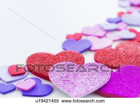 Stock Photography - Studio Shot of foam hearts on white background. Fotosearch