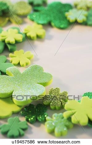 Stock Photograph - Studio Shot of green foam clovers. Fotosearch