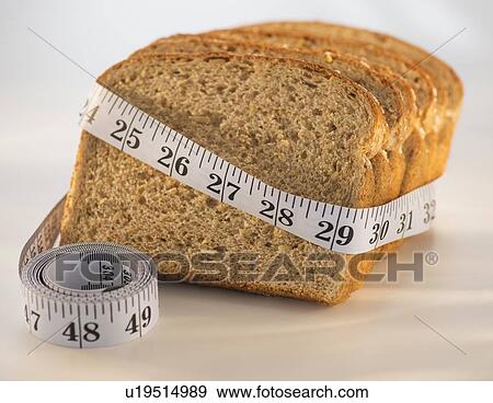 Studio Shot of measuring tape wrapped around slices of bread View Large Photo Image Stock Photo - Studio Shot of measuring tape wrapped around slices of bread. Fotosearch