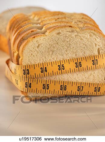 Studio Shot of measuring tape wrapped around slices of bread View Large Photo Image Stock Photograph - Studio Shot of measuring tape wrapped around slices of bread. Fotosearch