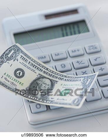 Studio Shot of one dollar bill and calculator View Large Photo Image Stock Photograph - Studio Shot of one dollar bill and calculator. Fotosearch