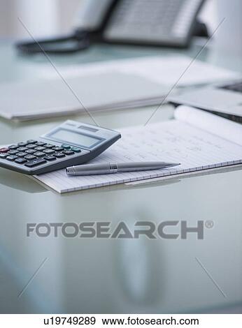 Stock Photo - Studio Shot of pen and calculator. Fotosearch