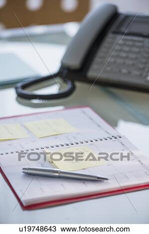 Stock Image - Studio Shot of pen and calendar. Fotosearch