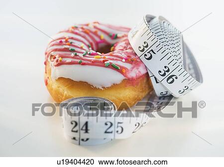 Studio Shot of tape measure wrapped around jelly doughnut View Large Photo Image Stock Image - Studio Shot of tape measure wrapped around jelly doughnut. Fotosearch