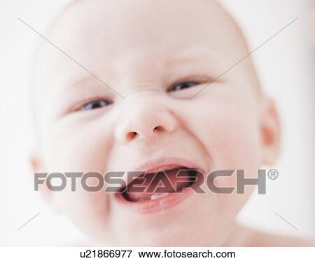 Stock Photo - Studio shot portrait of baby boy (18-23 months) with open mouth. Fotosearch