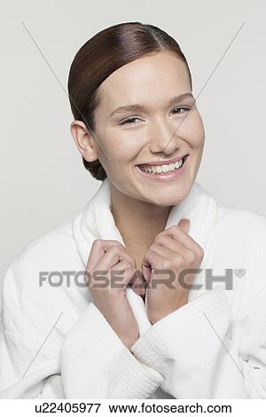 Stock Photo - Studio shot portrait of young woman in bathrobe. Fotosearch