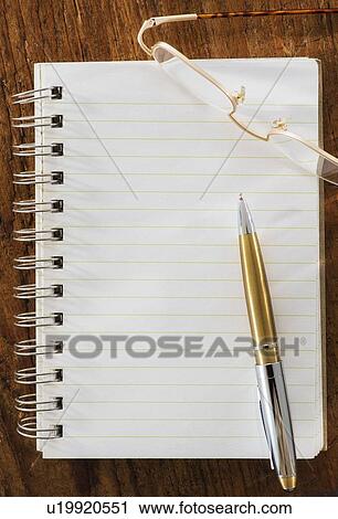Stock Image - Studio Shot spiral-bound notebook and pen. Fotosearch
