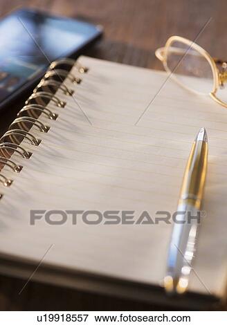 Studio Shot spiral-bound notebook and pen View Large Photo Image Stock Photo - Studio Shot spiral-bound notebook and pen. Fotosearch