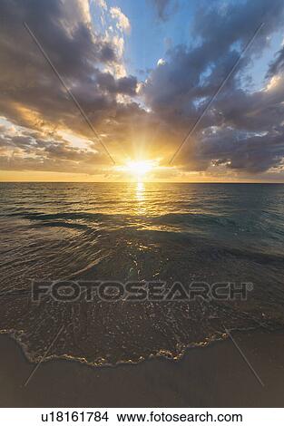 Picture - Sun setting over sea. Fotosearch