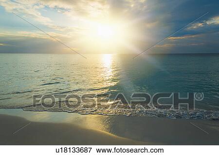 Sun setting over sea View Large Photo Image Stock Photo - Sun setting over sea. Fotosearch