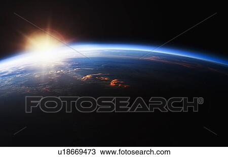 Stock Image - Sunrise over Planet Earth. Fotosearch