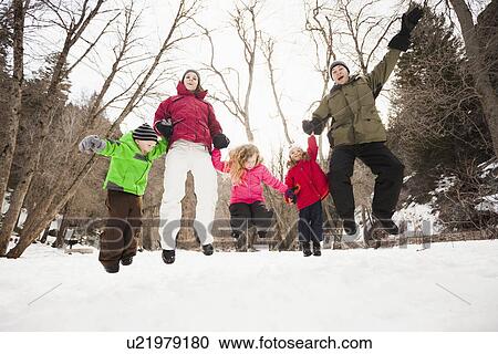 Stock Image - Three children (2-3, 4-5) with parents during stroll. Fotosearch