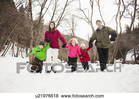 Stock Photo - Three children (2-3, 4-5) with parents during stroll. Fotosearch
