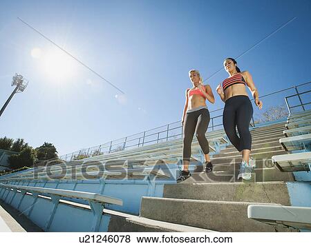 Two women walking down steps View Large Photo Image Stock Photo - Two women walking down steps. Fotosearch