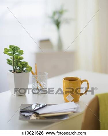 View of mug, flower pot, mobile phone and paper on table View Large Photo Image Stock Photograph - View of mug, flower pot, mobile phone and paper on table. Fotosearch