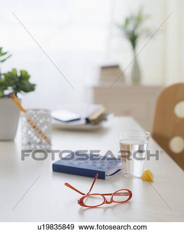 View of spectacles, personal organizer and glass of water on table View Large Photo Image Stock Photo - View of spectacles, personal organizer and glass of water on table. Fotosearch