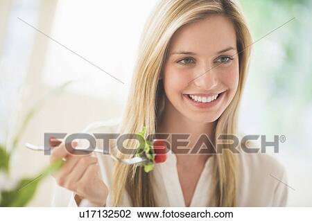 Woman eating and smiling View Large Photo Image Stock Image - Woman eating and smiling. Fotosearch