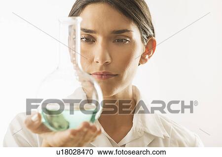 Woman holding beaker with liquid View Large Photo Image Stock Image - Woman holding beaker with liquid. Fotosearch