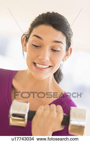 Woman lifting dumbbell View Large Photo Image Picture - Woman lifting dumbbell. Fotosearch