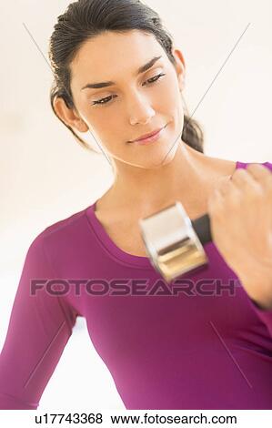 Woman lifting dumbbell View Large Photo Image Stock Photo - Woman lifting dumbbell. Fotosearch