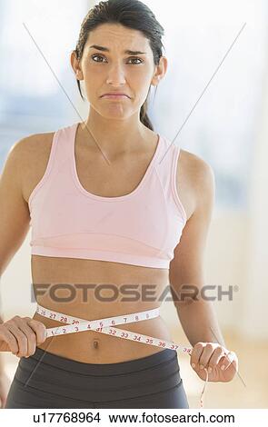 Picture - Woman measuring waist. Fotosearch