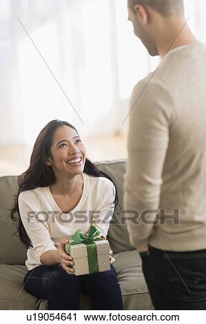 Woman receiving wrapped present View Large Photo Image Stock Image - Woman receiving wrapped present. Fotosearch