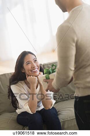Woman receiving wrapped present View Large Photo Image Stock Photo - Woman receiving wrapped present. Fotosearch