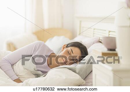 Woman sleeping in bed View Large Photo Image Stock Image - Woman sleeping in bed. Fotosearch