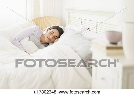 Woman sleeping in bed View Large Photo Image Stock Photo - Woman sleeping in bed. Fotosearch