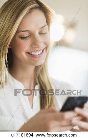Woman texting on smartphone View Large Photo Image Picture - Woman texting on smartphone. Fotosearch