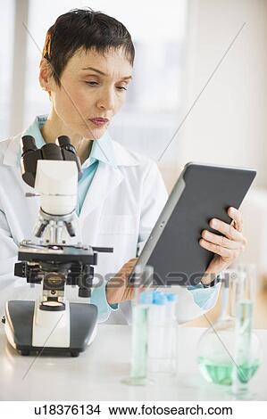 Woman using digital tablet in laboratory View Large Photo Image Picture - Woman using digital tablet in laboratory. Fotosearch