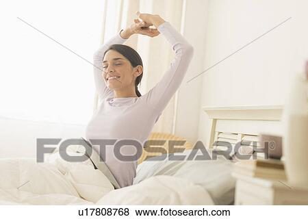 Woman waking up View Large Photo Image Stock Photo - Woman waking up. Fotosearch