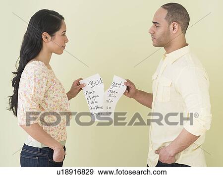 Young couple fighting over home budget View Large Photo Image Stock Photo - Young couple fighting over home budget. Fotosearch