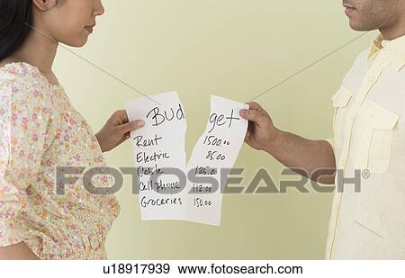 Young couple fighting over home budget View Large Photo Image Stock Photo - Young couple fighting over home budget. Fotosearch