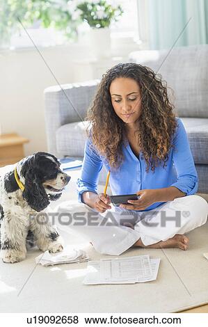 Young woman dealing with home finance View Large Photo Image Stock Photo - Young woman dealing with home finance. Fotosearch