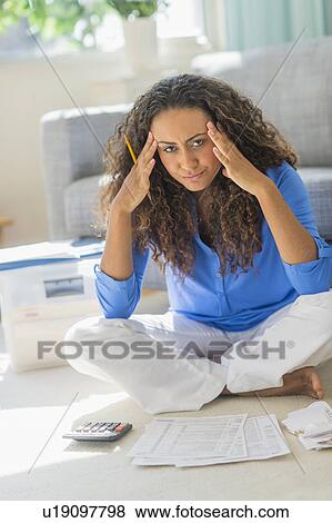 Stock Photo - Young woman dealing with home finance. Fotosearch