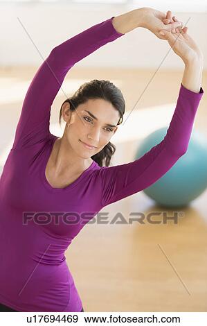 Young woman exercising View Large Photo Image Stock Photo - Young woman exercising. Fotosearch