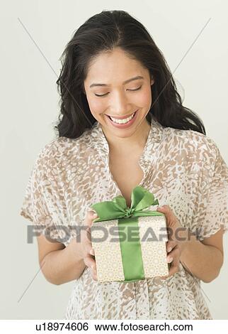 Young woman holding present View Large Photo Image Stock Photograph - Young woman holding present. Fotosearch