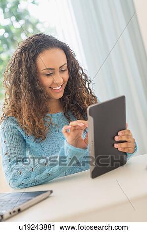 Young woman in home office View Large Photo Image Stock Image - Young woman in home office. Fotosearch