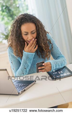 Young woman in home office View Large Photo Image Stock Image - Young woman in home office. Fotosearch