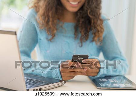 Young woman in home office View Large Photo Image Stock Image - Young woman in home office. Fotosearch